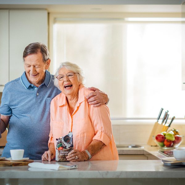 Enjoying the kitchen, coffee and a laugh at their apartment at Karana Retirement Living